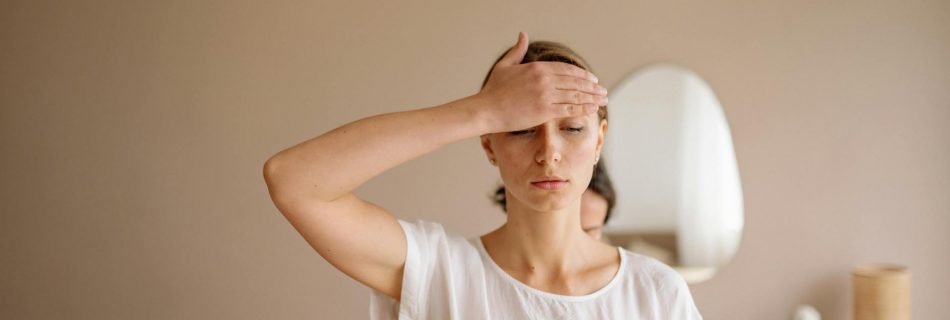 a woman touching her forehead