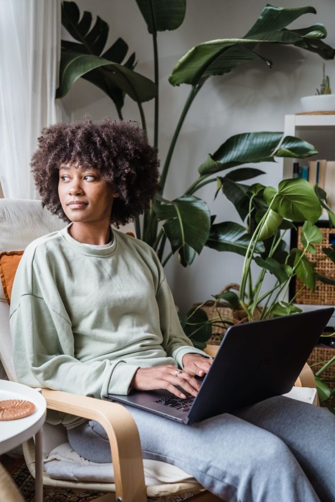 woman sitting on chair with laptop