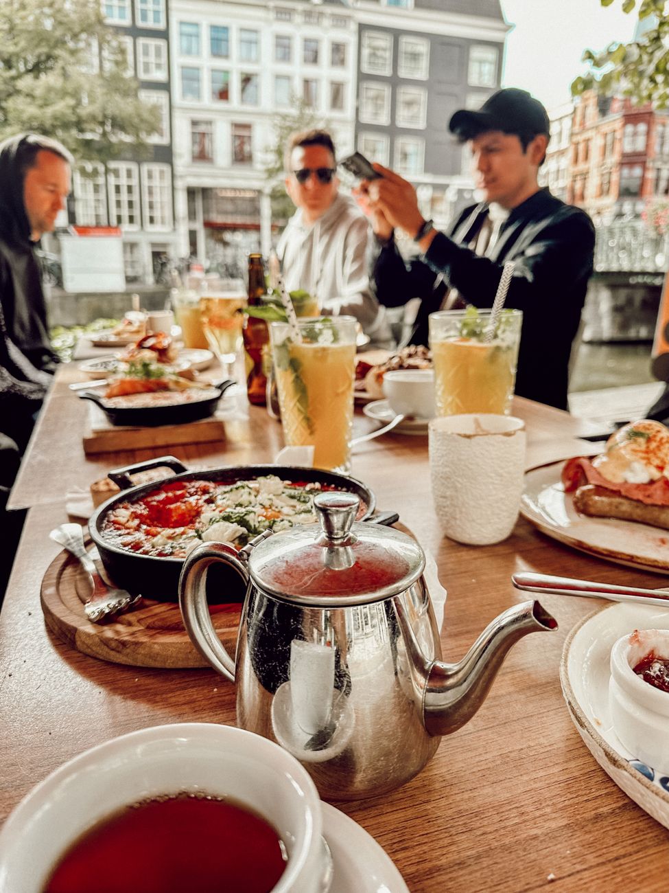 men over table with food at restaurant